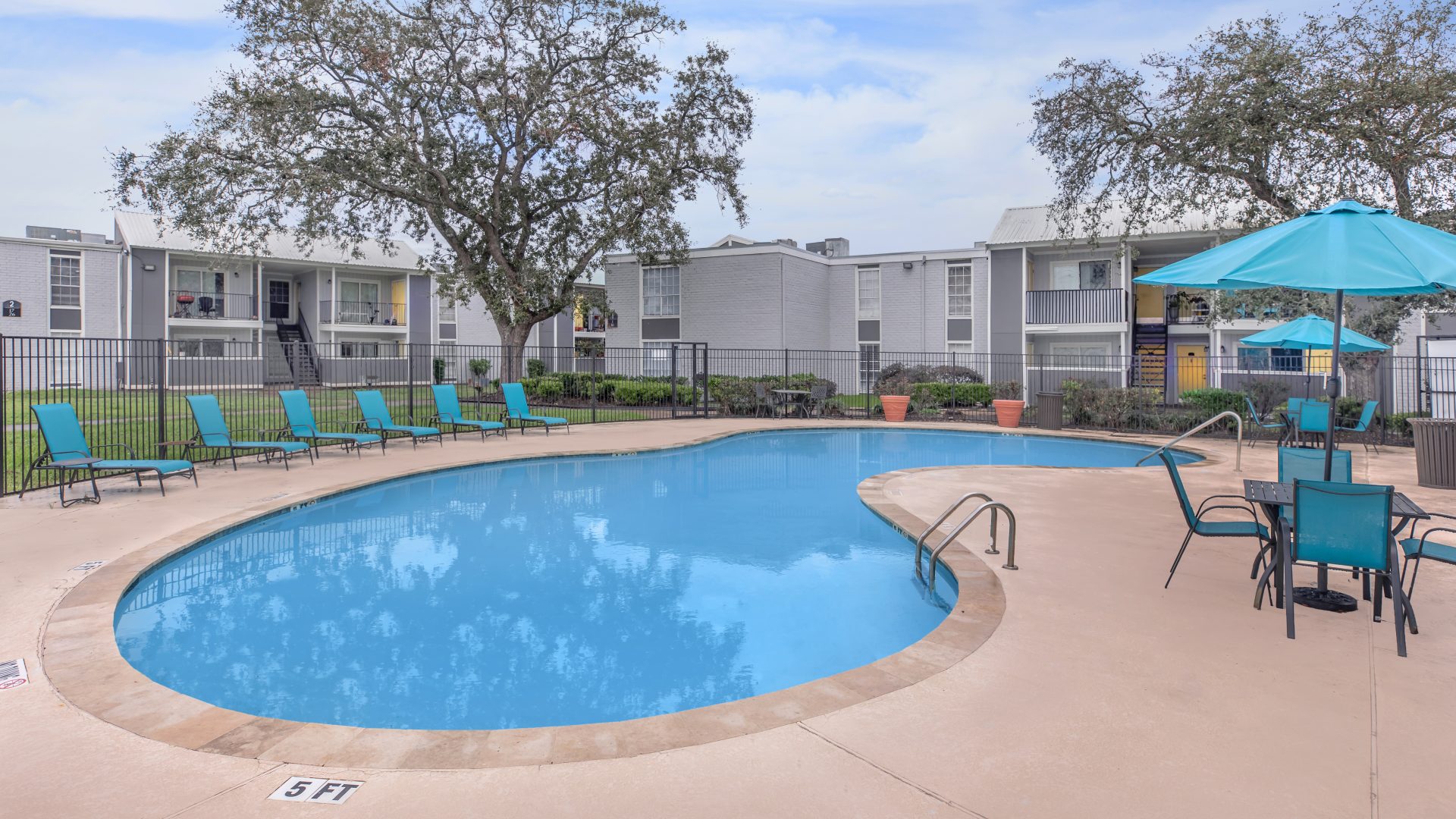 a pool with a pool table and chairs in it